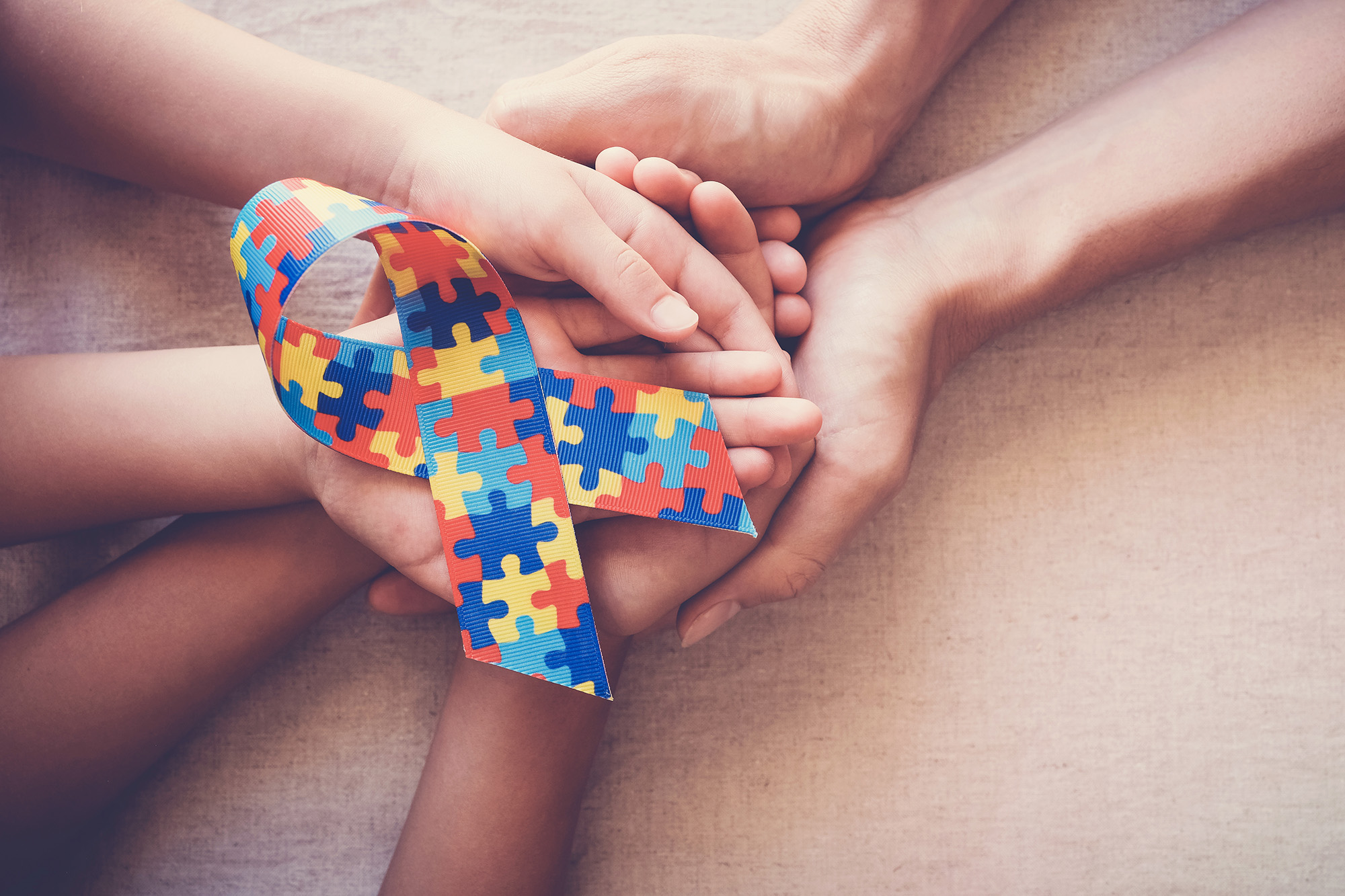 holding-puzzle-ribbon-autism-awareness
